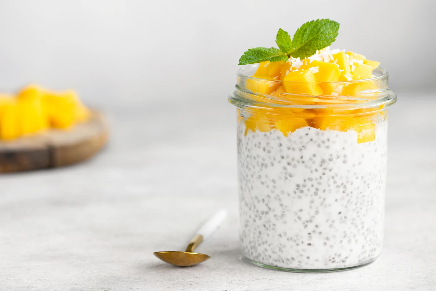 Chia pudding with fresh mango and mint representing healthy natural nutrition and balanced living.